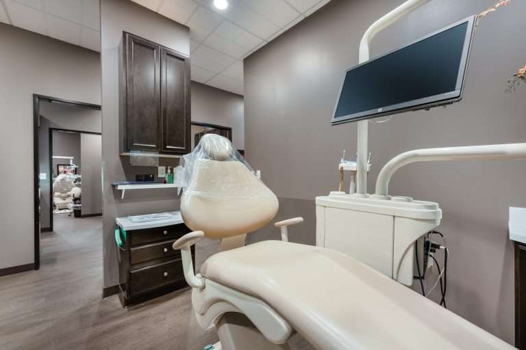 Ready operatory at Sacramento Dentistry Group with a dental chair and overhead monitor, prepared for a same day emergency appointment